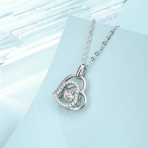 Diamond Heart pendant with a Dancing Moissanite Diamond in the center.
